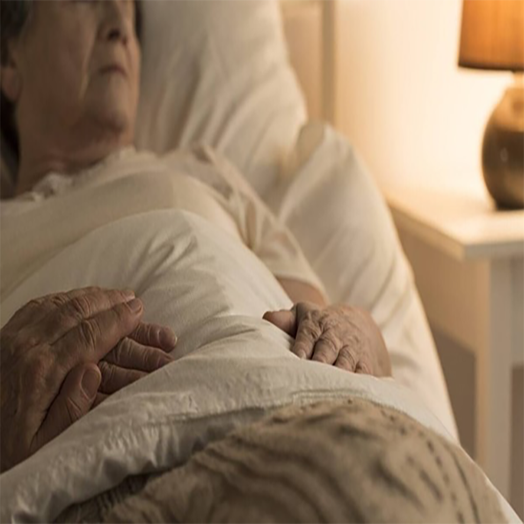 Elderly woman sleeping in Joshua's House Hospice bed