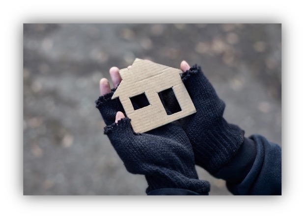 Hands holding a cardboard house